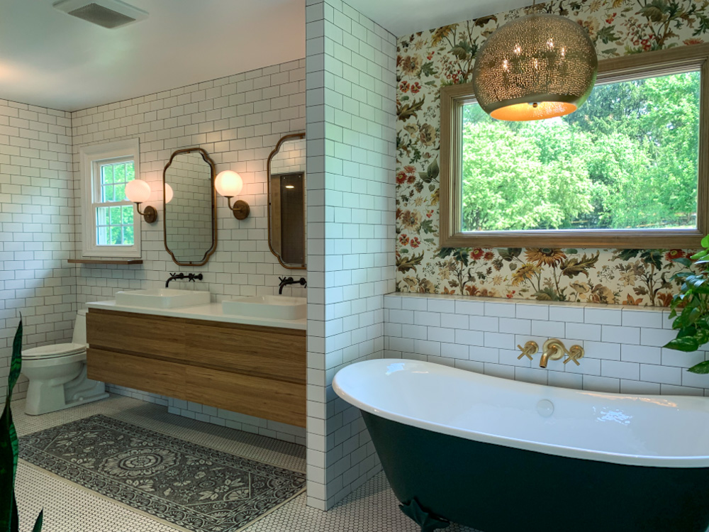 Stonewall Renovations bathroom with a tiled vanity wall and freestanding bathtub