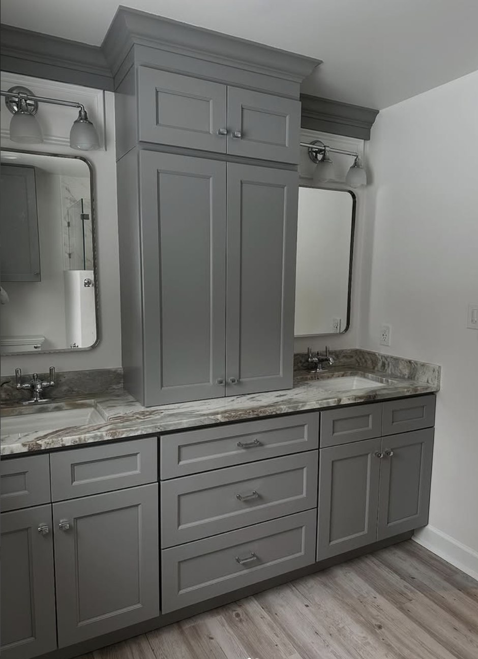 Stonewall Renovations gray double vanity with custom center storage and stone countertop