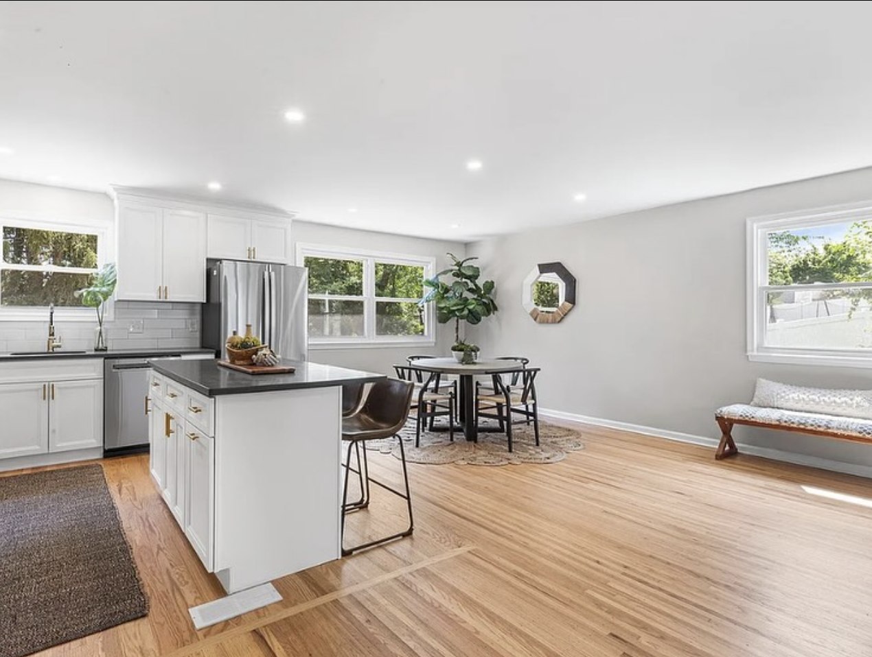 Stonewall Renovations open-concept white kitchen and dining room
